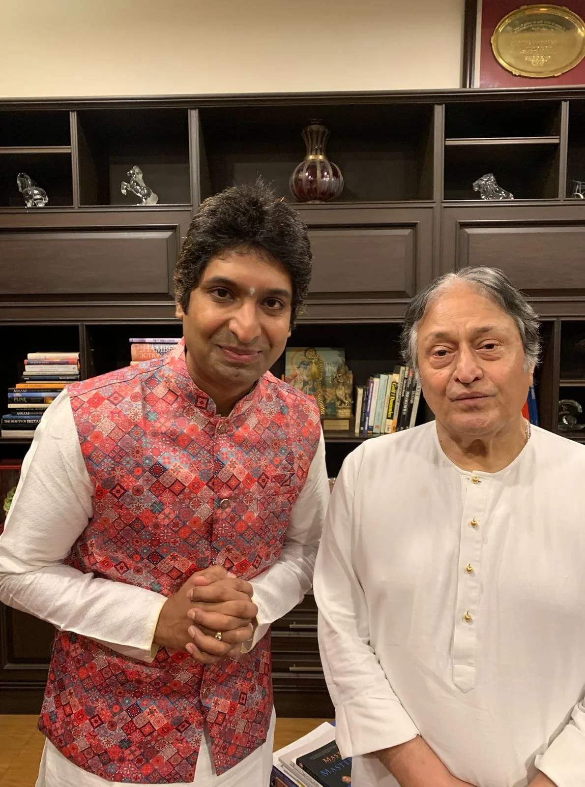 Dr. Koustubh Pare with a senior mentor in a library setting